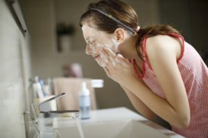 Girl washing her face